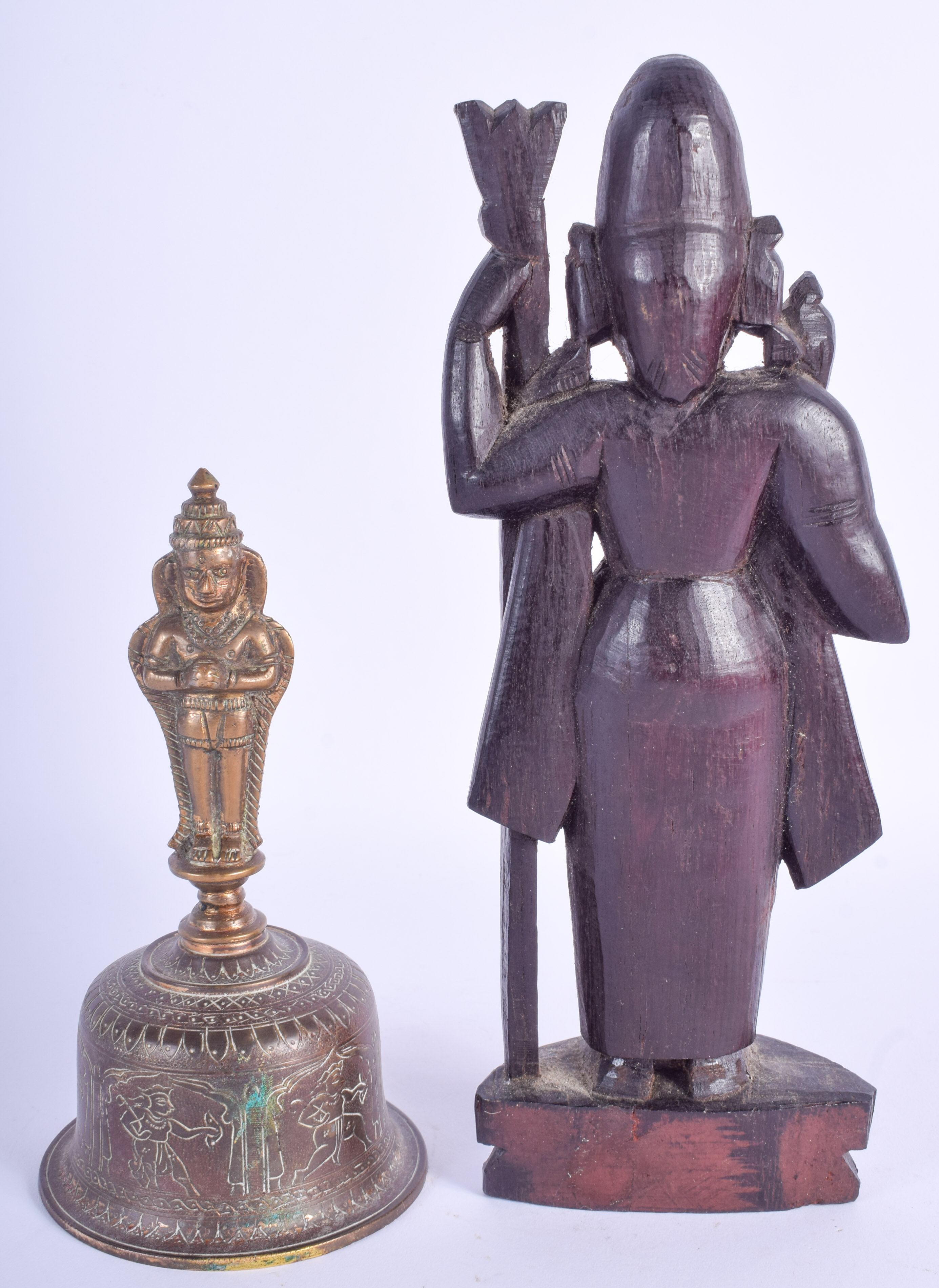 A 19TH CENTURY INDIAN CARVED HARDWOOD FIGURE OF A DEITY together with a similar bell. 23 cm & 16 cm - Image 2 of 3