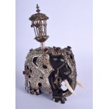 AN ANTIQUE INDIAN IVORY ELEPHANT with silver and gem stone mounts. 9 cm x 11 cm.
