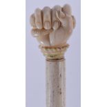 AN 18TH/19TH CENTURY CONTINENTAL CARVED IVORY SAILORS FIST CANE with whalebone shaft. 86 cm long.