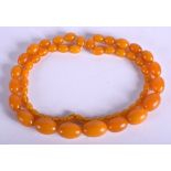 A 1930S EUROPEAN HONEY BEAD NECKLACE possibly amber. 85 grams. 84 cm long, largest bead 2.5 cm wide.