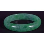 AN EARLY 20TH CENTURY CHINESE CARVED JADEITE BANGLE Late Qing. 6.5 cm wide.