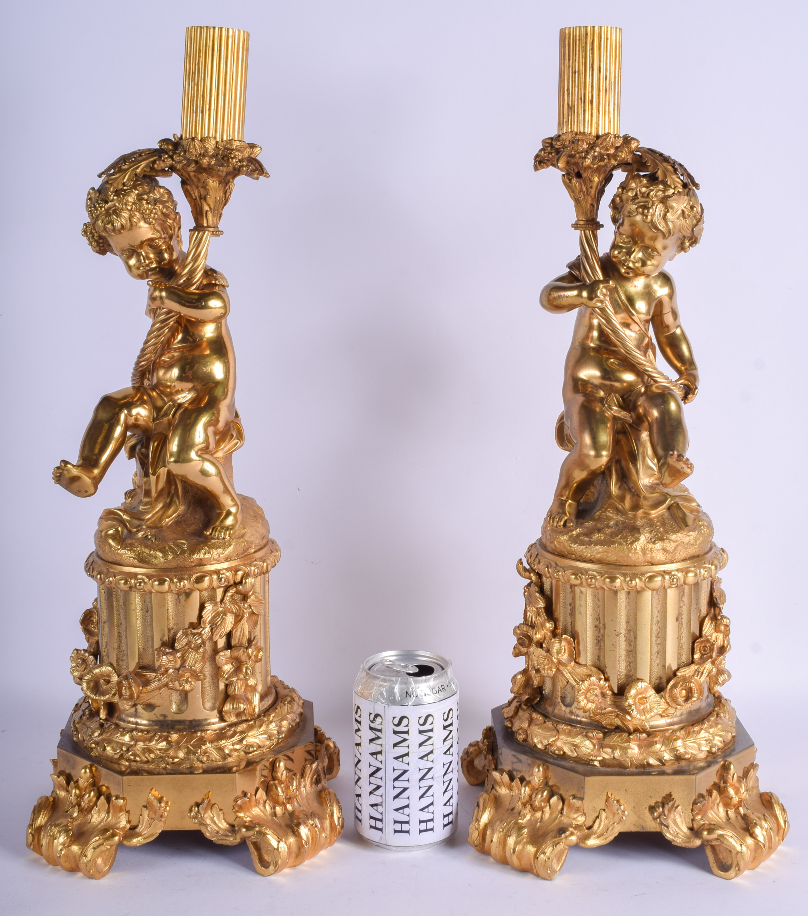 A LARGE PAIR OF 19TH CENTURY FRENCH ORMOLU CANDLEABRA formed with putti. 45 cm high.