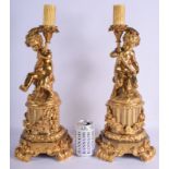 A LARGE PAIR OF 19TH CENTURY FRENCH ORMOLU CANDLEABRA formed with putti. 45 cm high.