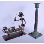 AN ARTS AND CRAFTS BRONZE CANDLESTICK together with a nuts & bolts figure. Largest 25 cm high. (2)