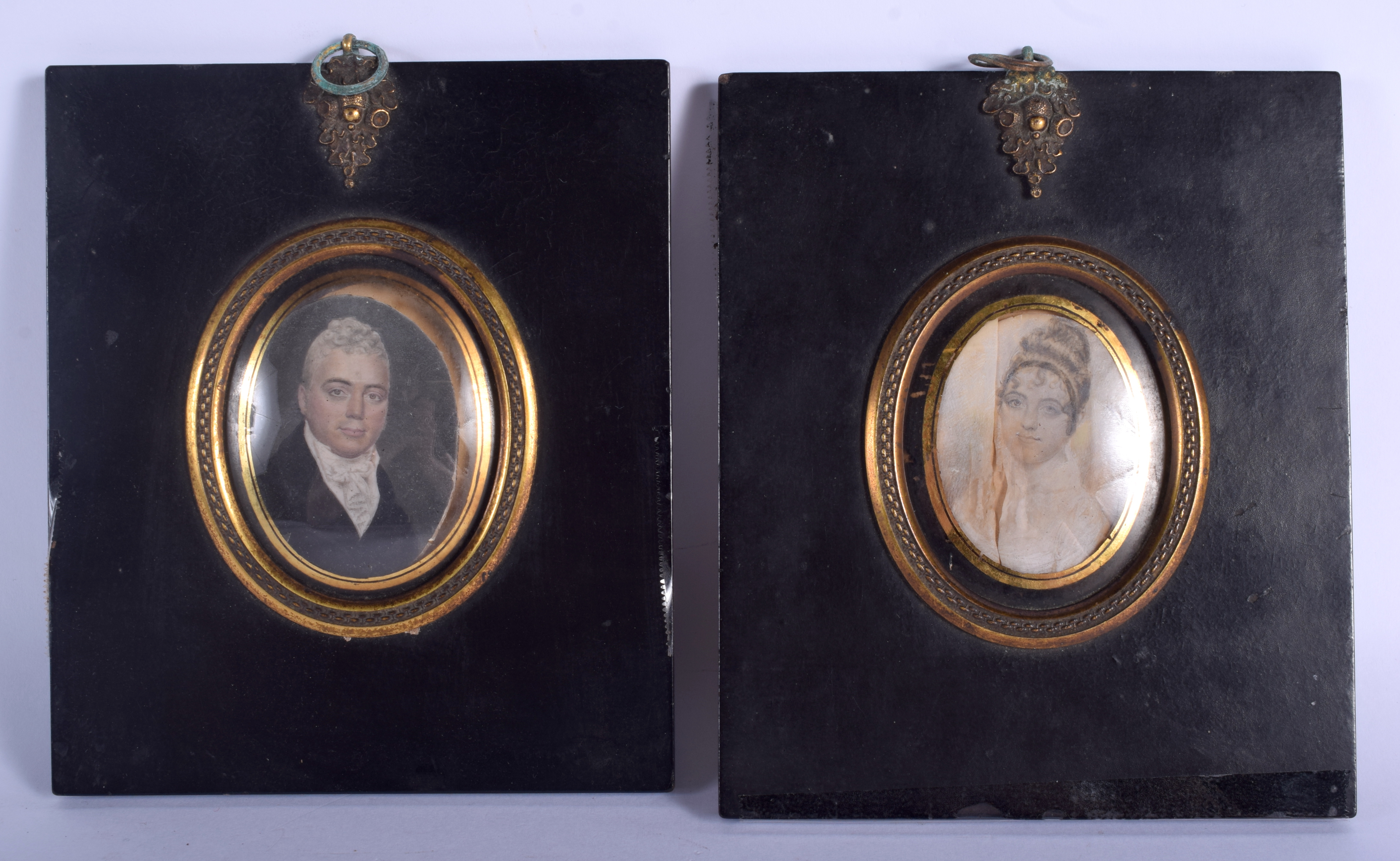 A PAIR OF GEORGE III PAINTED IVORY PORTRAIT MINIATURES. Image 5 cm x 7.5 cm.