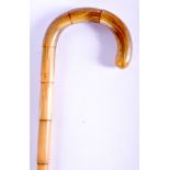 A 19TH CENTURY CONTINENTAL CARVED FULL LENGTH RHINOCEROS HORN HANDLED WALKING CANE of bamboo form. 8