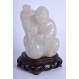 AN EARLY 20TH CENTURY CHINESE CARVED GREY JADE FIGURE Late Qing/Republic, modelled holding aloft a m