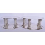 A NEAR PAIR OF 19TH CENTURY SILVER PLATED PEDESTAL STAND. Largest 15 cm wide.