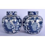 A PAIR OF 19TH CENTURY CHINESE BLUE AND WHITE GINGER JARS AND COVERS Kangxi style. 21 cm x 13 cm.