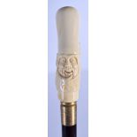 A CONTINENTAL CARVED BONE HANDLED WALKING CANE. 90 cm long.