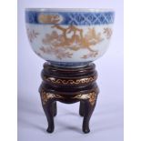 A 19TH CENTURY JAPANESE MEIJI PERIOD PORCELAIN BOWL upon a lacquered stand. Bowl 10 cm x 5 cm. (2)