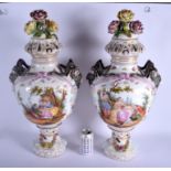 A LARGE PAIR OF EARLY 20TH CENTURY GERMAN PORCELAIN VASES AND COVERS Meissen style, painted with lov