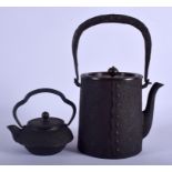 AN 18TH CENTURY JAPANESE EDO PERIOD CAST IRON TEAPOT AND COVER together with a smaller teapot. Large