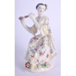 Bow figure of a female musician seated and playing the flute wearing a flowered dress raised on a p