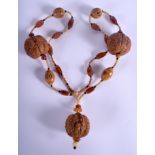 AN EARLY 20TH CENTURY CHINESE CARVED NUT AND HORN NECKLACE. 86 cm long.