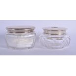 TWO ANTIQUE SILVER TOPPED DRESSING TABLE JARS. 10 cm wide. (2)
