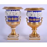 A PAIR OF 19TH CENTURY FRENCH PARIS PORCELAIN PEDESTAL VASES encrusted with flowers. 20 cm high.