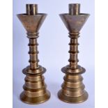 A PAIR OF 18TH/19TH CENTURY BRONZE CANDLESTICKS of unusual stepped form. 24 cm high.