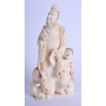 A 19TH CENTURY JAPANESE MEIJI PERIOD CARVED IVORY OKIMONO modelled as a scholar beside two children.