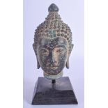 AN EARLY 20TH CENTURY THAI SOUTH EAST ASIAN BRONZE BUDDHA HEAD upon an ebonised base. Bronze 13 cm x