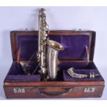 A VINTAGE SAXOPHONE within a fitted leather case. 55 cm long.