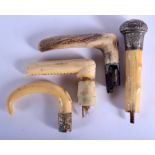 A 19TH CENTURY CONTINENTAL CARVED IVORY WALKING CANE HANDLE together with three other handles. Large