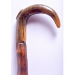 A 19TH CENTURY CONTINENTAL CARVED RHINOCEROS HORN HANDLED WALKING CANE. 88 cm long.