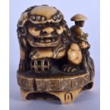 A GOOD 18TH/19TH CENTURY JAPANESE EDO PERIOD CARVED IVORY NETSUKE modelled as a shi shi dog upon an
