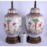A LARGE PAIR OF EARLY 20TH CENTURY CHINESE FAMILLE ROSE JARS AND COVERS Guangxu, Yongzheng style. Po