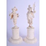 A PAIR OF 19TH CENTURY EUROPEAN CARVED BONE DIEPPE FIGURES modelled upon a cylindrical base. 21 cm