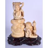 A 19TH CENTURY JAPANESE MEIJI PERIOD CARVED IVORY OKIMONO modelled as a female beside daikoku. Ivory