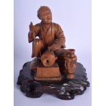 A 19TH CENTURY JAPANESE MEIJI PERIOD CARVED BOXWOOD OKIMONO modelled as a male artisan. 17 cm x 11 c