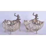 A PAIR OF ANTIQUE CONTINENTAL SILVER BOWLS formed with a leaping cherub. 23 oz. 19 cm x 13 cm.