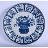 A LARGE 19TH CENTURY CHINESE BLUE AND WHITE PORCELAIN DISH Kangxi style, painted with flowers and a