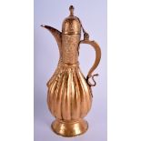 AN ISLAMIC MIDDLE EASTERN GILDED COPPER EWER decorated with foliage. 32 cm high.