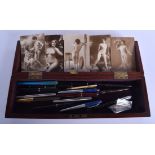 A VICTORIAN CARVED MAHOGANY RECTANGULAR CASE together with a collection of erotic cards & pens. (qty