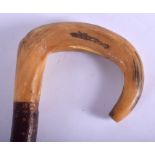 A 19TH CENTURY CONTINENTAL CARVED RHINOCEROS HORN HANDLED WALKING CANE. 88 cm long.