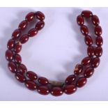 A 1920S EASTERN RED AMBER NECKLACE. 20 grams. 36 cm long.