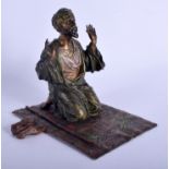 A 19TH CENTURY AUSTRIAN COLD PAINTED BRONZE ARABIC MALE modelled praying upon a rug. 15 cm x 15 cm.