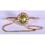 A VICTORIAN 15CT GOLD PEARL AND PERIDOT BROOCH. 2.4 grams. 3.5 cm wide.