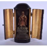 A 19TH CENTURY JAPANESE MEIJI PERIOD POLYCHROMED WOOD SHRINE inset with a standing buddha. 11 cm hig
