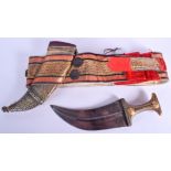 A 19TH CENTURY OMANI MIDDLE EASTERN CARVED RHINOCEROS HORN DAGGER inset with yellow metal coins. 38