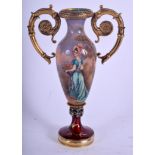 AN UNUSUAL CONTINENTAL TWIN HANDLED SILVER GILT AND ENAMEL CUP painted with a female within a landsc