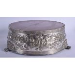 A 19TH CENTURY CONTINENTAL SILVER PLATED EMBOSSED STAND decorated with foliage. 38 cm x 15 cm.
