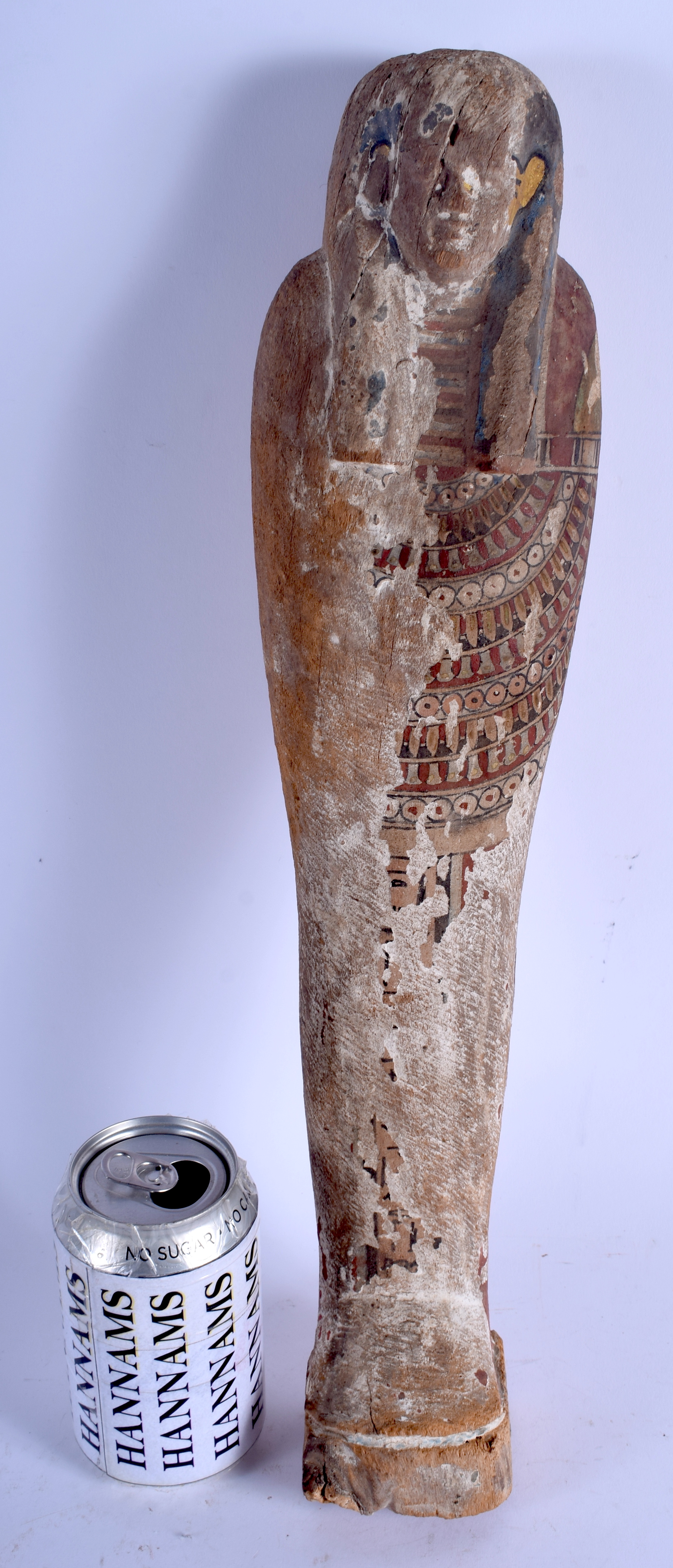 A LARGE AND EARLY EGYPTIAN PAINTED POLYCHROMED WOOD USHABTI possibly Middle Kingdom, modelled encase