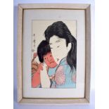 A 19TH CENTURY JAPANESE MEIJI PERIOD WOODBLOCK PRINT depicting a female holding a red faced child. I