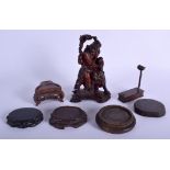 A 19TH CENTURY CHINESE CARVED HARDWOOD FIGURE OF AN IMMORTAL together with hardwood stands. (7)