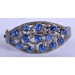 A CONTINENTAL SILVER GOLD DIAMOND AND SAPPHIRE BANGLE. 33.4 grams. 6.5 cm wide.