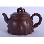 A CHINESE YIXING POTTERY TEAPOT AND COVER Late Qing/Republic, overlaid with foliage. 17 cm wide.