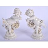 A PAIR OF EARLY 20TH CENTURY WHITE GLAZED PORCELAIN FIGURES modelled upon a shaped base. 16 cm high.